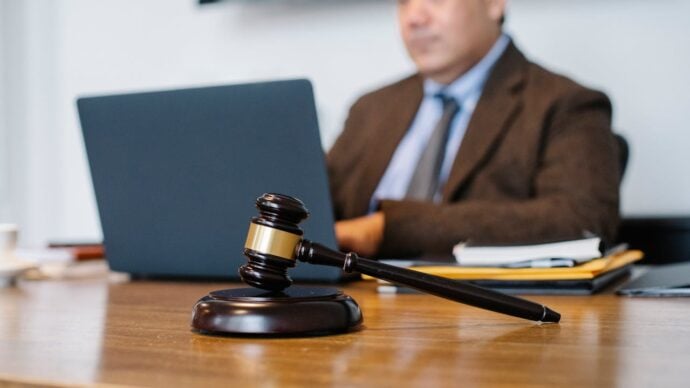 Photo by Sora Shimazaki: https://www.pexels.com/photo/crop-asian-judge-working-on-laptop-in-office-5668772/