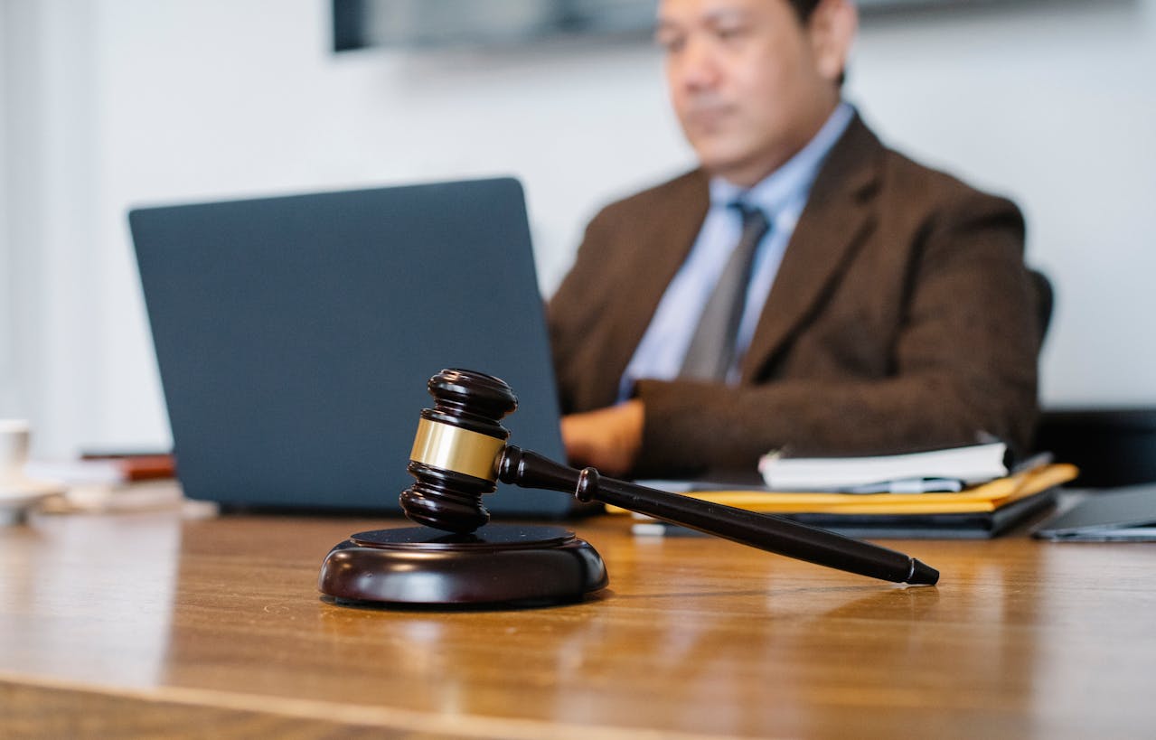 Photo by Sora Shimazaki: https://www.pexels.com/photo/crop-asian-judge-working-on-laptop-in-office-5668772/